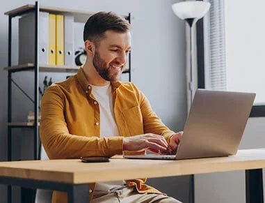 Guy On Computer Using Loan Rocket for Personal Loans